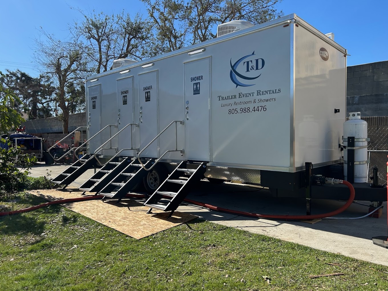 Premium shower trailer at an upscale outdoor event at golden hour
